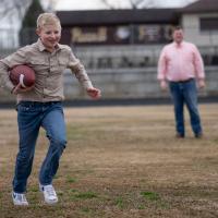 William Dean runs with a football