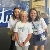 William Dean poses for a photo at a UK football game with members of the Lift Them Up team