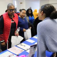 Attendees speak with one of the event exhibitors.