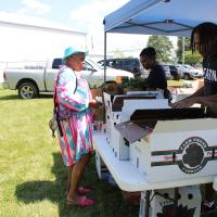 An event attendee speaks with an exhibitor.