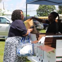 An event attendee speaks with an exhibitor.