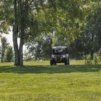 Bruce Drake rides a in a motorized vehicle on his farm.