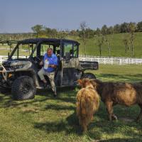 Bruce Drakes exists a small vehicle to feed his two cows.