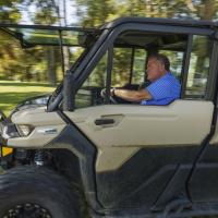 Bruce Drake driving a small vehicle to traverse his fam.