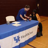 A nurse measuring blood pressure of a person