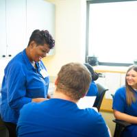 Beata laughs with her coworkers.