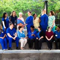 Beata and her coworkers laugh and smile in their group photo.