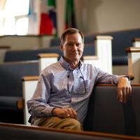 Bill Crawford sitting in a church pew