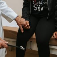 A close-up photo of Brandi squeezing Dr. Avasarala’s hand in the examination room.