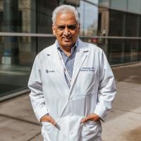 A photo of Dr. Avasarala smiling for the camera with his hands in the pockets of his lab coat.