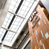 A shot looking up at the “UK College of Pharmacy” sign in one of the buildings on campus.