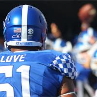 A close-up view of Courtney during his football days, wearing a jersey and helmet, viewed from behind.