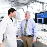 Dr. McLarney talks with Dr. Gurley in the hospital.