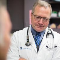 Dr. Mullett listens while his patient talks.