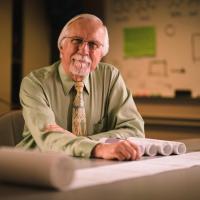 Dr. Ed Kasarskis posing with his research documents