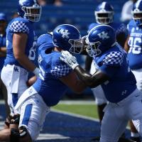 An action shot of Eli sparring with one of his teammates on the field.