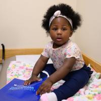 A photo of Betty sitting on the bench of an examination room at a doctor’s office.