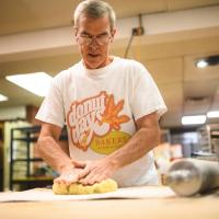 Fred prepares to work with some dough to make donuts.