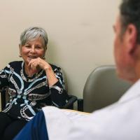 Gayle listens to Dr. van Horne talk.