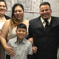 Faith's family, including her mother, three siblings, and stepfather Beto, all smile for a family photo.