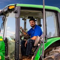 Jacob drives his John Deere tractor.