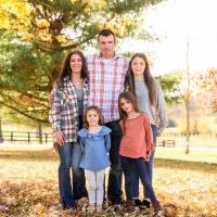 A photo of the Shaughnessy family posing together outside for a photo.