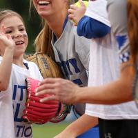 A candid photo of Kailey on the softball field about to give one of the players a high five.