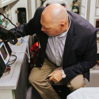 A photo of Matt reading the screen of one of the pieces of equipment inside the ambulance.