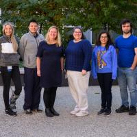 A group photo of Dr. Kolesar along with the other Molecular Tumor Board members smiling for the camera as they post together outside.