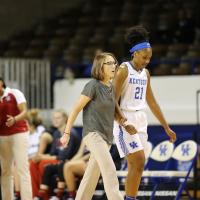 Ogechi walks off the court next to the team physician.