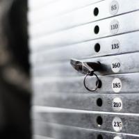 Close up of weight machine weights set to 160 pounds.