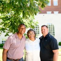 Priscilla's son and pastor stop for a group photo with Priscilla.