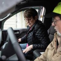 Debbie settles into the passenger seat in her husbands truck while he sits in the drivers seat.