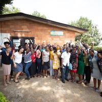 Dr. Shenoi and a large group of doctor's and nurses she trained cheer for a group photo.