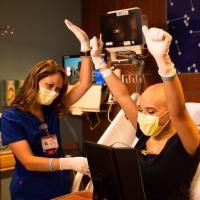 Savannah and her nurse do a victory cheer after Savannah successfully accesses her own port.