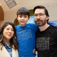 Liz, Maximo, and Benjamin pose for a family photo together.