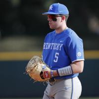 A candid shot of T.J. holding a bat over his shoulder and waiting for a pitch. His back is to the camera.