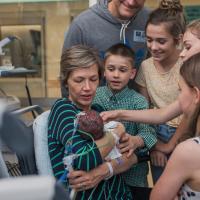 The Duerson family gathers around Karla, who is holding an infant Wylie, to meet their new family member for the first time.