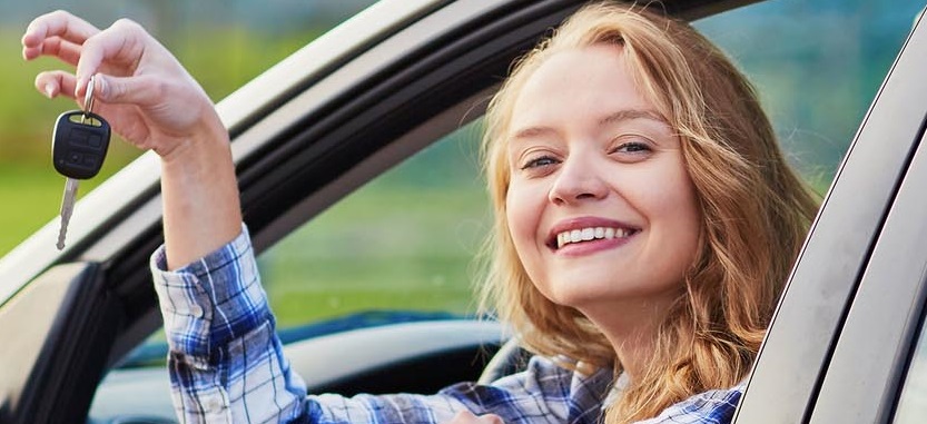 Teen girl holds up car keys