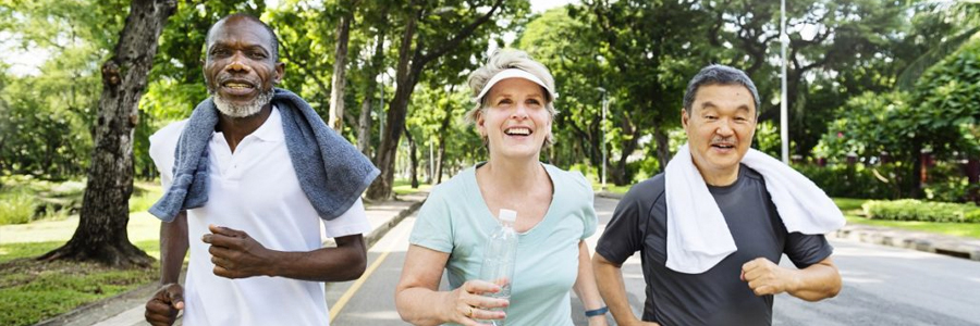 Three senior friends jog together.