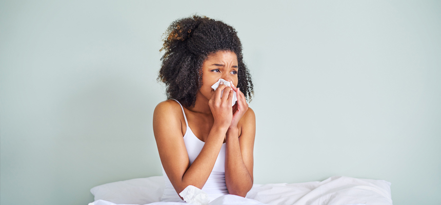 Woman blowing her nose