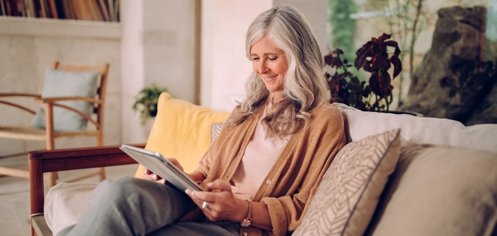 Woman looks at her tablet.