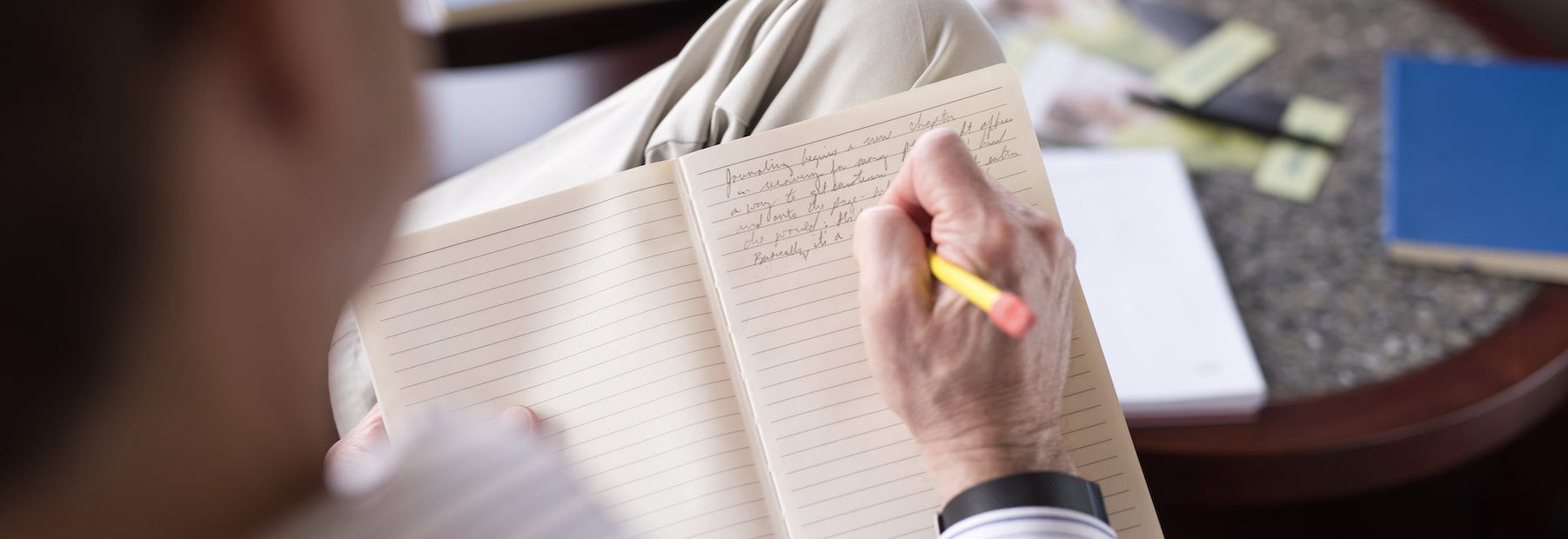 Person writing in journal. 