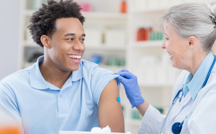 A young man gets a flu shot.